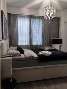 a bedroom with a bed with a large window at Private Room next to Helsinki-Vantaa Airport in Vantaa