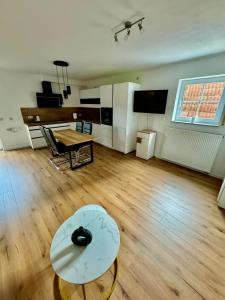 a living room with a table and a coffee table at Adenauer Forst Ring Apartment in Adenau +11 photos