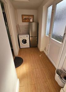 a small kitchen with a refrigerator and a stove at Wolves Living in Bushbury