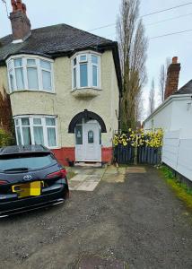 a black car parked in front of a house at Wolves Living in Bushbury