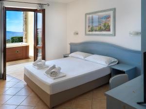 a bedroom with a bed with towels on it at Residence Besass, GTSGroup in Tignale