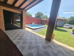 a patio with a view of a swimming pool at Hospedaje Confortable en Luque in Luque