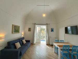 波西塔諾的住宿－Regina Margherita，客厅配有蓝色的沙发和桌子