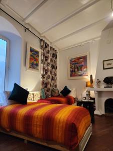 a bedroom with two beds and a fireplace at Dar Adul in Essaouira