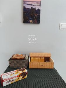 a table with two boxes of snacks and a picture at COSY Living Apartment 1 in Kos Town
