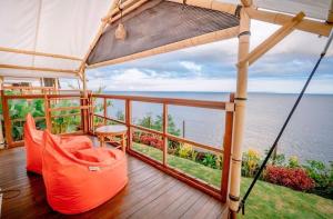 a balcony with a view of the ocean at Bali Cliff Glamping in Karangasem