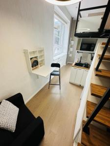 a small living room with a table and a chair at City Apartments in Tallinn