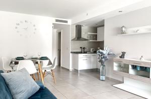 a living room with a blue couch and a kitchen at Paradise Palms I Deluxe, incl. Welcome Package in Corralejo
