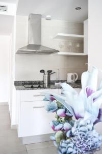 a kitchen with a counter with a flower on it at Paradise Palms I Deluxe, incl. Welcome Package in Corralejo