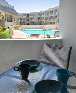 a table with three blue cups on top of a balcony at Paradise Palms I Deluxe, incl. Welcome Package in Corralejo
