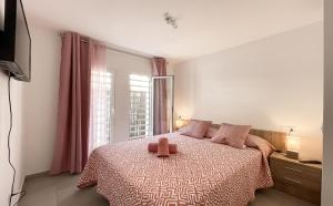 a bedroom with a bed with a brown object on it at Paradise Palms I Deluxe, incl. Welcome Package in Corralejo