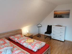 a bedroom with two beds and a dresser and a desk at Ferienwohnung Fleischer in Mitterteich