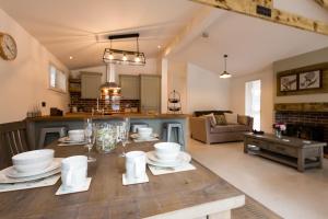 a kitchen and living room with a wooden table at Lochness lodge in Fort Augustus