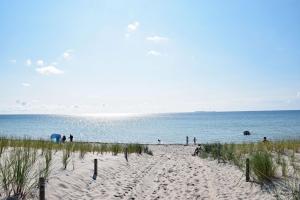 a group of people on a beach near the water at Strandhaus Goehren in Göhren