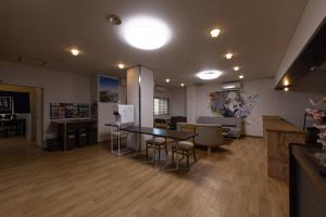 a large room with a table and chairs in it at Hostel JAQ takamatsu in Takamatsu