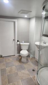 a bathroom with a toilet and a sink at Dieppe Apartment in Dieppe