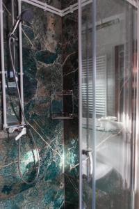 a bathroom with a glass shower with a sink at Pensiunea Poiana de Vis in Suceviţa