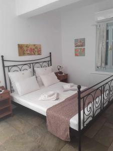 a bedroom with a large bed with white pillows at Villa Filitsa in Platis Gialos