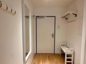 a white room with a door and a mirror at Balcony Apartment I 50 m² I Near City Center in Vienna