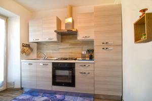 a kitchen with wooden cabinets and a stove at Nel blu dipinto di blu in Malesco
