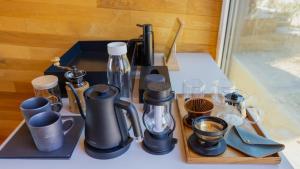 a tray with coffee makers and cups on a table at ALPS LAPS withTENAR in Kami-iino