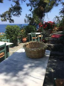 a basket on a table with a table and chairs at Atlantis Hotel in Samos