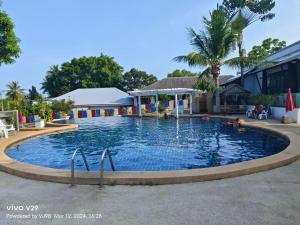 a large swimming pool in front of a building at Siri Maya Garden Home Samui in Koh Samui 