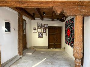 a room with a wall with paintings on the walls at Usman Heritage in Bukhara