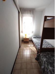 A bed or beds in a room at Cozy studio near the beach - Beahost