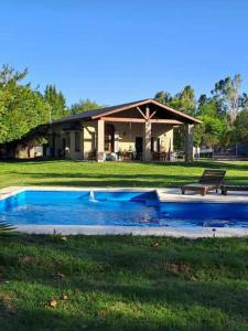 una casa con piscina en el césped en Quinta Oasis de Paz en Los Cardales en Campana