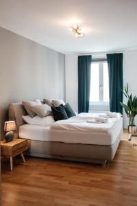 a bedroom with a large bed with green curtains at Gray Dream I stilvoll und neu in Hannover
