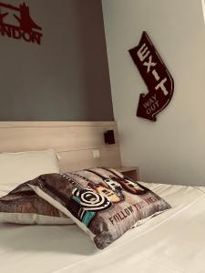- une couverture sur un lit avec un panneau mural dans l'établissement Hotel centre Rouen, à Rouen