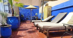 a row of chaise lounge chairs on a patio at RIAD MAMAHOUSE in Marrakech