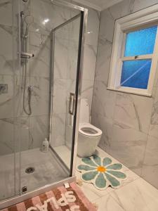 a bathroom with a shower and a toilet at Auckland Airport apartment in Auckland
