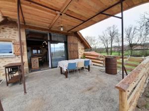 a patio with a table and chairs on it at LeS GITES CAMBOIS in Cambes