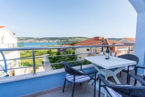 a balcony with a table and chairs and a view at Apartman PANTAN in Trogir