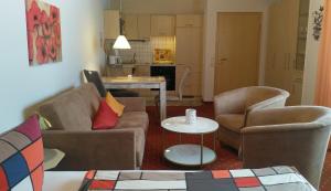 a living room with two chairs and a table at Ferienhaus am Sonnenhang in Willingen