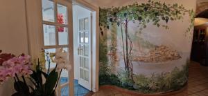 a mural on the wall of a room with flowers at Albergo La Conca Azzurra in Conca dei Marini