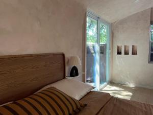 a bedroom with a bed and a large window at Terra Villeta - at lumicollection in Miami