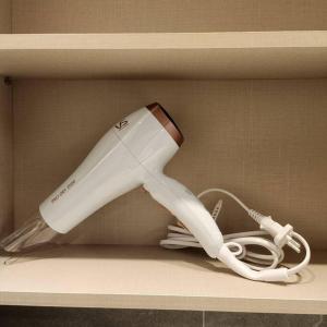 a white hair dryer sitting on a shelf at Beautiful Sunset Jejubi House2 in Jeju