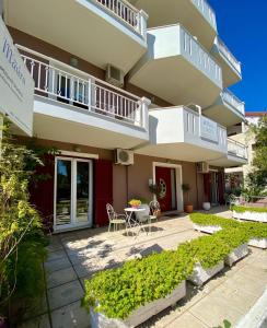 a building with a patio and a table in front of it at Casa di Maura in Lefkada Town