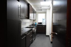 a kitchen with stainless steel appliances and a window at Peace House-private room with bathroom for 2 guest in Dubai