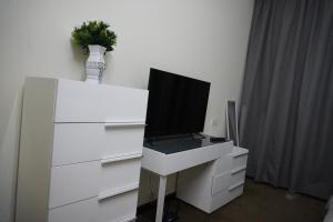 a white dresser with a tv on top of it at Peace House-private room with bathroom for 2 guest in Dubai