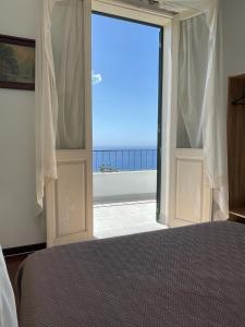 a bedroom with an open door with a view of the ocean at Vila São Gonçalo in Funchal