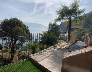 a balcony with a view of the water at Villa Angelina Guest House in Cannero Riviera