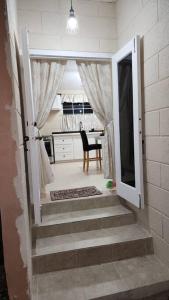 a stairway leading into a kitchen with a door open at Welcome to our 1 bedroom villa in Bridgetown