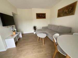 a living room with a couch and a table at Spring apartment in Permet in Përmet