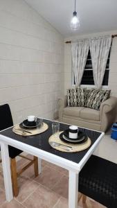 a living room with a table and a couch at Welcome to our 1 bedroom villa in Bridgetown