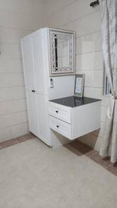 a white dresser with a mirror in a room at Welcome to our 1 bedroom villa in Bridgetown