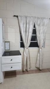 a room with a window with a white dresser at Welcome to our 1 bedroom villa in Bridgetown